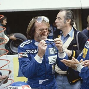 1983 French Grand Prix: Keke Rosberg watches team mate Jacques Lafitte try on some sun glasses