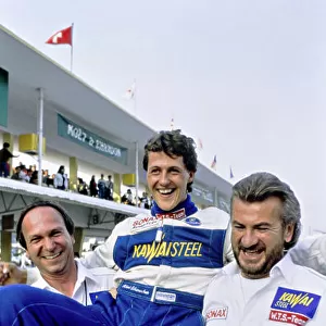 1990 Macau Formula 3 Grand Prix. Macau, China. 25th November 1990. Michael Schumacher (Reynard 903-Volkswagen), 1st position, carried by Manager Willi Weber, portrait. World Copyright: LAT Photographic. Ref: 90F3MAC06