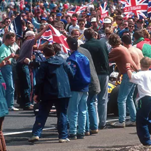 1992 British Grand Prix. Silverstone, England. 10-12 July 1992. When Nigel Mansell (Williams FW14B Renault) 1st position, drove around on his victory lap the fans invaded the track as Mansell mania hit its peak