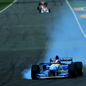 1995 BRITISH GP. Johnny Herbert smokes up his tyres on his way to victory at his home