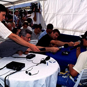 1995 HUNGARIAN GP. Michael Schumacher is invaded by microphones at the press