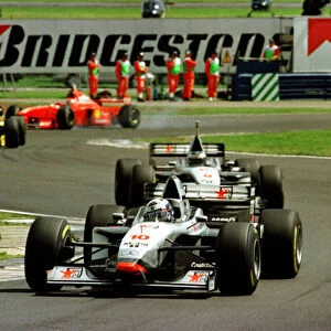 1997 BRITISH GP. David Coulthard leads team mate Mika Hakkinen early on during