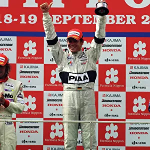 2004 Formula Nippon Championship Sepang, Malaysia. 19th September 2004 Race winner Andre Lotterer (PIAA Nakajima), podium. World Copyright: Yasushi Ishihara/LAT Photographic ref: Digital Image Only