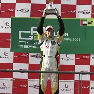 2008 GP2 Asia Series. Friday Race. Dubai. Dubai Autodrome. 11th April. Romain Grosjean (FRA, ART Grand Prix) celebrates victory on the podium. World Copyright: Alastair Staley/GP2 Series Media Service. Service ref:__MG_4845. jpg