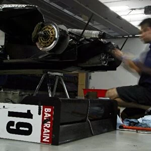 Bahrain F3 Superprix: A Carlin mechanic works into the Bahrain evening