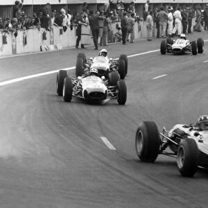 Charade, Clermont-Ferrand, France: Graham Hill, 5th position leads Jo Siffert, 6th position, Jo Bonnier, retired and Denny Hulme, 4th position