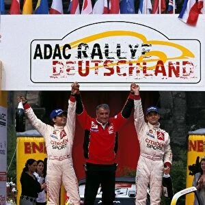 FIA World Rally Championship: Daniel Elena, Guy Frequelin Citroen Rally boss and Sebastien Loeb celebrate the first WRC victory for Loeb