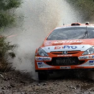 FIA World Rally Championship: Henning Solberg, Peugeot 307 WRC, leaps out of the watersplash on Stage 6