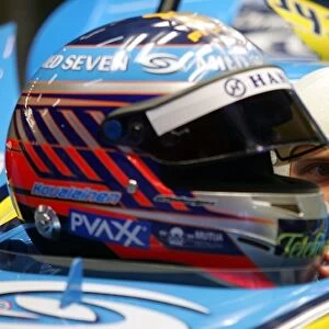 Formula One Testing: Heikki Kovalainen Renault talks with a representative of Bell helmets