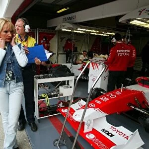 Formula One World Championship: Anne Panis, wife of Olivier Panis Toyota, shields her ears from the engine noise in the Toyota pit