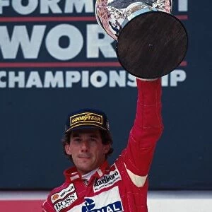 Formula One World Championship: Ayrton Senna celebrates his win on the podium