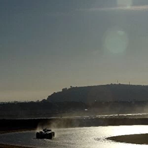 Formula One World Championship: A BMW Williams FW24 tests in the early morning sunshine on an artificially wet track