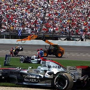 Formula One World Championship: The clear up after the first car pile up