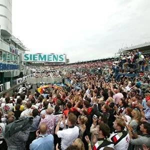 Formula One World Championship: The crowded pit lane in front of the podium