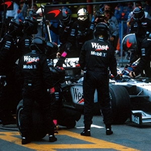Formula One World Championship: David Coulthard McLaren Mercedes MP4 / 13 makes a pitstop on his way to 2nd place