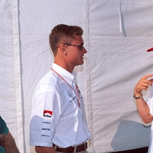 Formula One World Championship: David Coulthard Mclaren MP4-11 and Eddie Irvine Ferrari F310, right