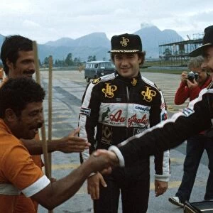 Formula One World Championship: Elio de Angelis, left and Nigel Mansell meet the locals