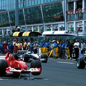 Formula One World Championship: The Ferrari F2002 of Rubens Barrichello was left stranded on its front jacks at the start of the parade lap