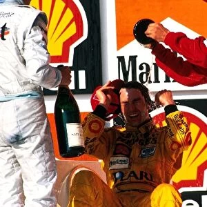 Formula One World Championship: Heinz-Harald Frentzen Jordan Mugen Honda 199 gets a bath on the podium