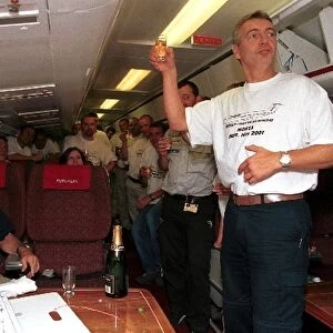 Formula One World Championship: ITV Commentator Tony Jardine raises a toast for Murray Walker aboard the European Aviation aeroplane after he
