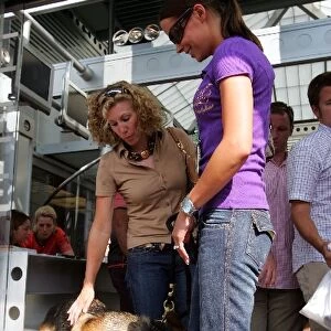 Formula One World Championship: Jenni Dahlman, right, wife of Kimi Raikkonen McLaren with dog