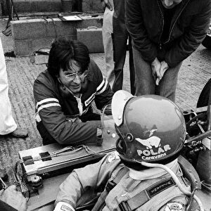 Formula One World Championship: Karl Kempf secures the data logging equipment into the sidepod of the Tyrrell P34 of Ronnie Peterson