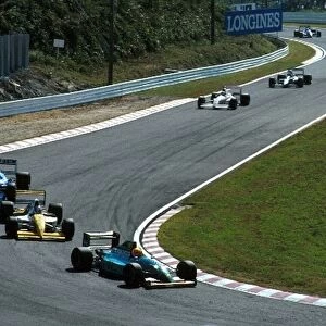 Formula One World Championship: Mauricio Gugelmin in the Leyton House holds up a queue of cars