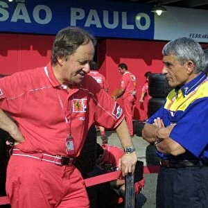 Formula One World Championship: Michelin Competition Director Pierre Dupasquier talks with a Ferrari engineer