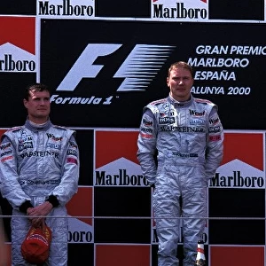 Formula One World Championship: The podium finishers David Coulthard McLaren 2nd, Mika Hakkinen McLaren 1st, Rubens Barrichello Ferrari 3rd