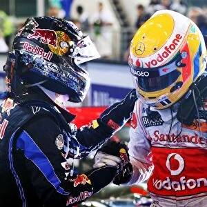 Formula One World Championship: Race winner and 2010 World Champion Sebastian Vettel Red Bull Racing and Lewis Hamilton McLaren in parc ferme