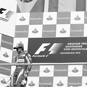 Formula One World Championship: Race winner Fernando Alonso Ferrari leaves the podium from the opposite side of second placed team mate Felipe