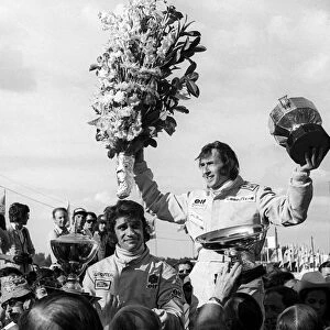 Formula One World Championship: Race winner Jackie Stewart Tyrrell celebrates on the podium with his second placed team mate Francois Cevert Tyrrell