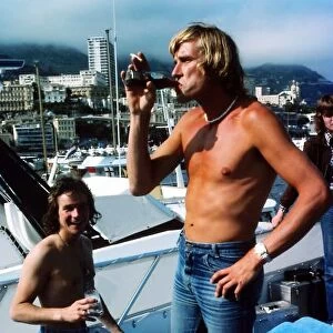 Formula One World Championship: Reigning World Motorcycle Champion Barry Sheene on a boat with reigning World Formula One Champion James Hunt McLaren
