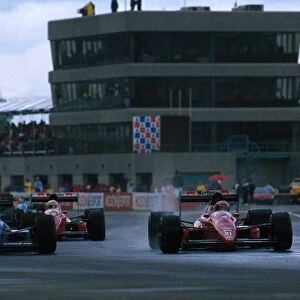 Formula One World Championship: Rene Arnoux Ligier JS22 and Alex Caffi Dallara F189 battle it out in the wet conditions