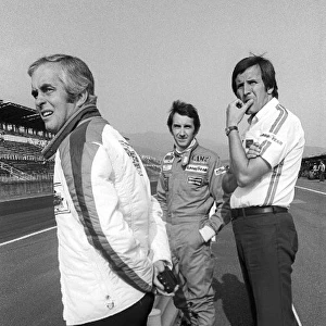 Formula One World Championship: Roger Penske Penske Team Owner stands on the pit wall with race retiree John Watson Penske, and Heinz Hofer