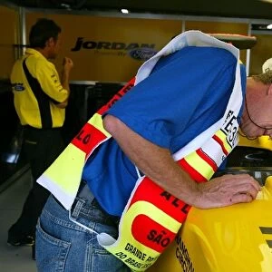 Formula One World Championship: Scrutineers in the Jordan garage look at the EJ13