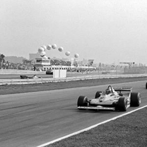 Formula One World Championship: Second placed Gilles Villeneuve Ferrari 312T4 leads the race from eventual race winner Alan Jones Williams FW07