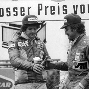 Formula One World Championship: second placed Jody Scheckter Tyrrell shares a beer on the podium with race winner Clay Regazzoni Ferrari