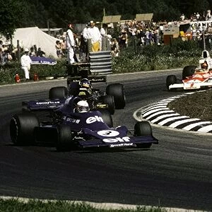 Formula One World Championship: Seventh placed Jody Scheckter Tyrrell 007 leads Ronnie Peterson Lotus 72E, who finished ninth, and Emerson Fittipaldi