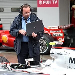 Formula One World Championship: Simon Busby FIA Software analyst checks a McLaren