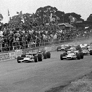 Formula One World Championship: Start, Pole position man Jochen Rindt Lotus 49B, left, has the jump on Jackie Stewart Matra MS80, right