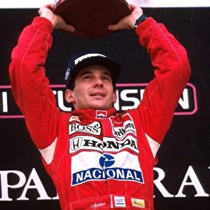 Formula One World Championship: Winner Ayrton Senna celebrates his win and world championship on the podium