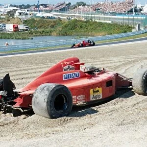 Formula One World Championship: The wreckage of the Ferrari 641 of Alain Prost passed by team mate Nigel Mansell Ferrari 641 after colliding