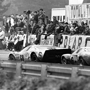 Le Mans, France. 14-15 June 1969: Helmut Kelleners / Reinhold Joest, Ford GT40, 6th position, leads Jacky Ickx / Jackie Oliver, Ford GT40, 1st position