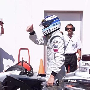 Mika Hakkinen celebrates pole position