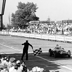 Nurburgring, Germany. 4 August 1957: Juan Manuel Fangio, 1st position. Fangio takes the chequered flag after his greatest win