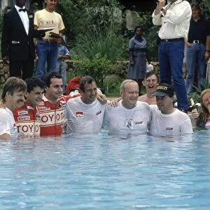 Safari Rally, Kenya. 11-16 April 1990: Toyota team celebrate including Luis Moya, Carlos Sainz, Bjorn Waldegard, Fred Gallagher in the swimming pool