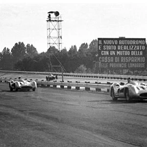 Winner Juan Manuel Fangio leads Strirling Moss (both: 1955 Italian Grand Prix, Monza