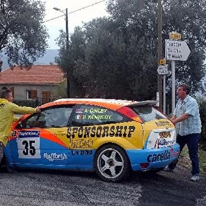 World Rally Championship: Alistair Ginley, Ford Focus, is pushed by the marshals after his car failed
