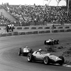 Zandvoort, Holland. 6 June 1960: Phil Hill, Ferrari Dino 246, retired, leads Innes Ireland, Lotus 18-Climax, 2nd position, and Alan Stacey, Lotus 18-Climax